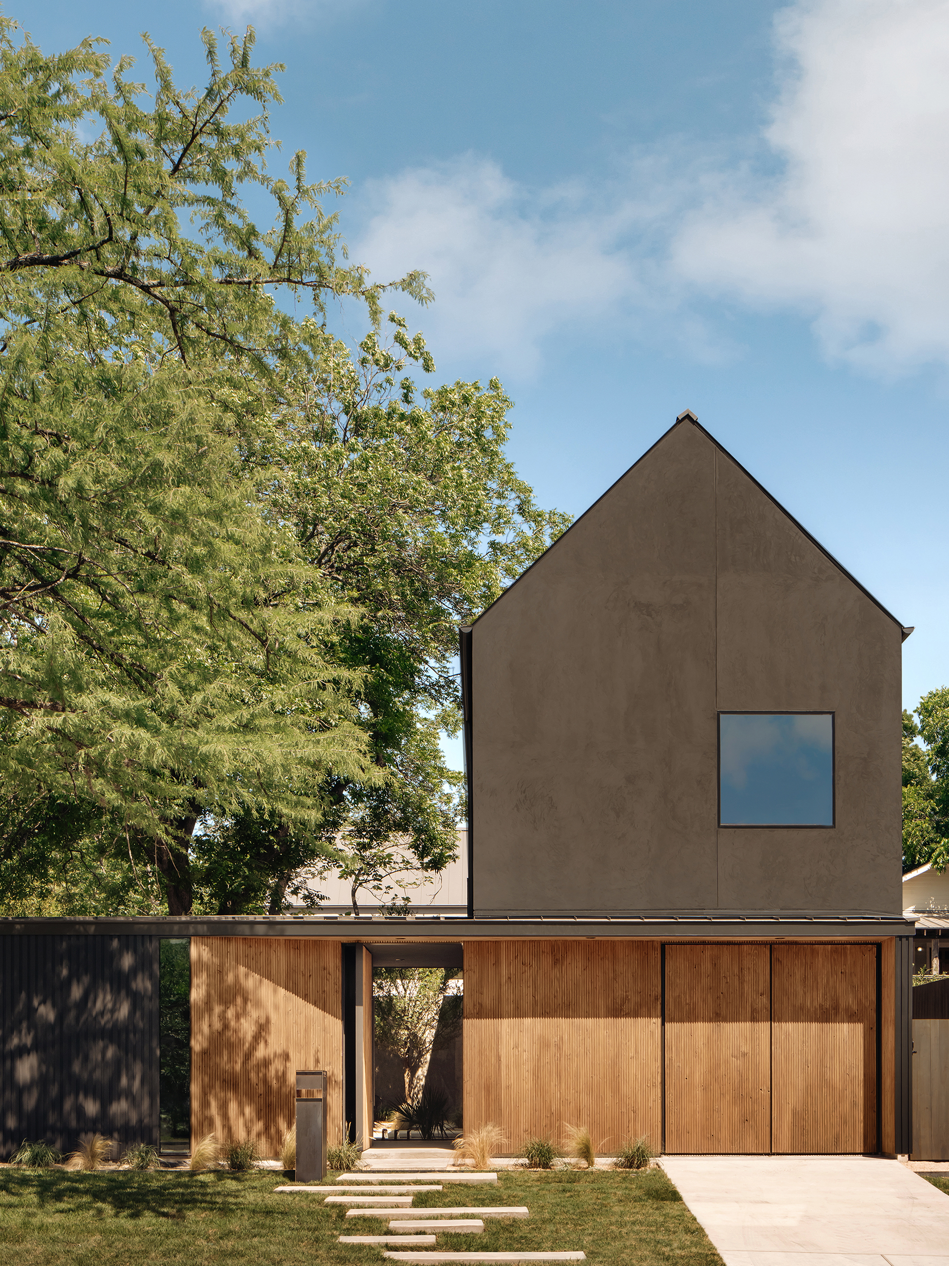 Side elevation, gabled black volume above concrete base